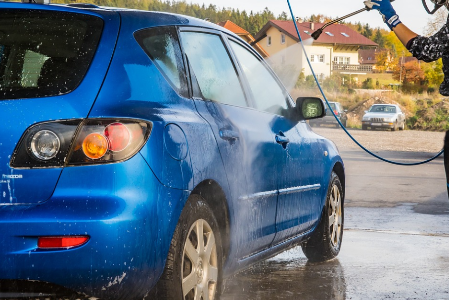 spraying car with hose